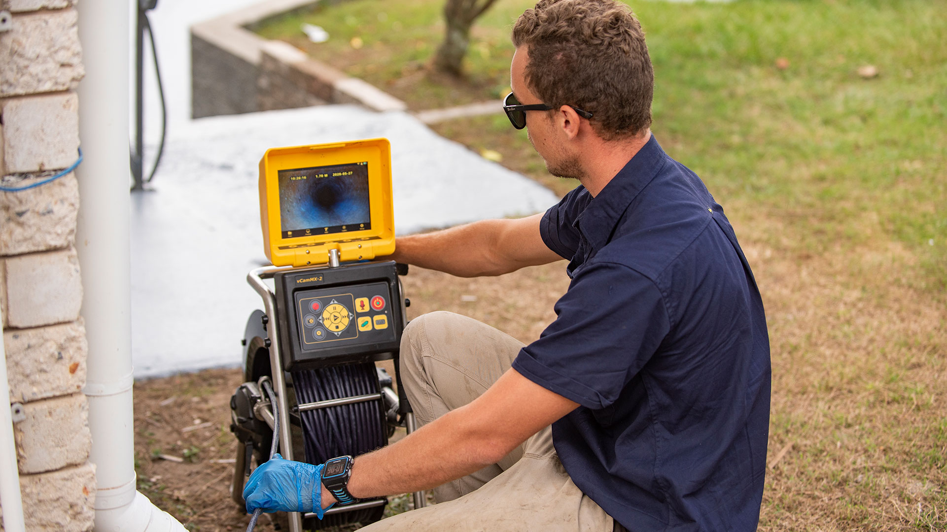 A Pasfield Plumber clearing blocked drains with a jetter and drain camera